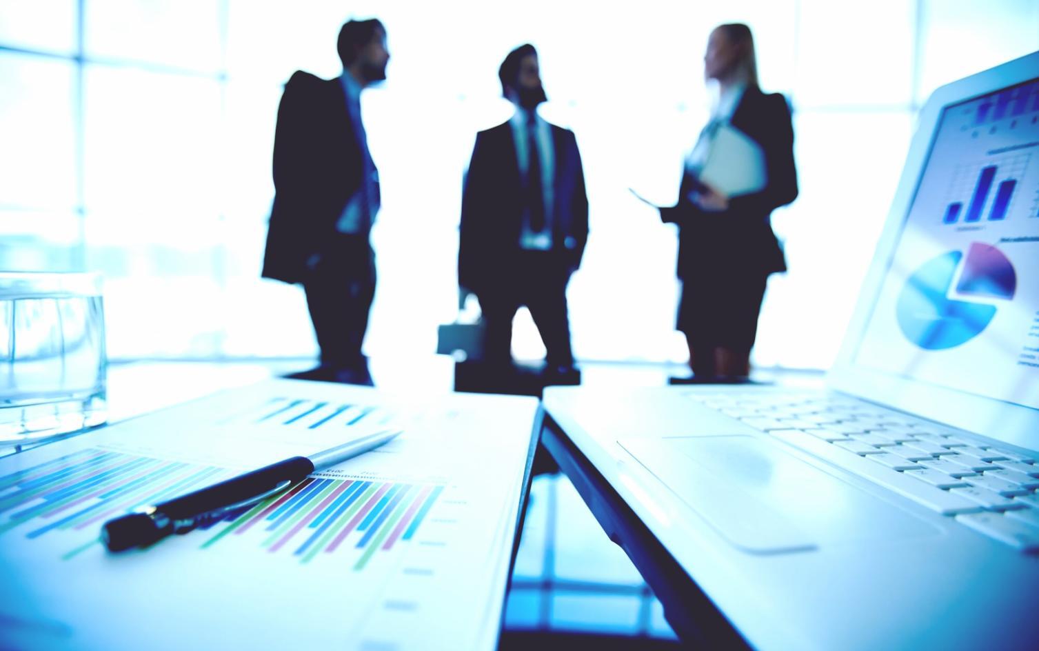 Business professionals analyzing financial data and discussing strategy